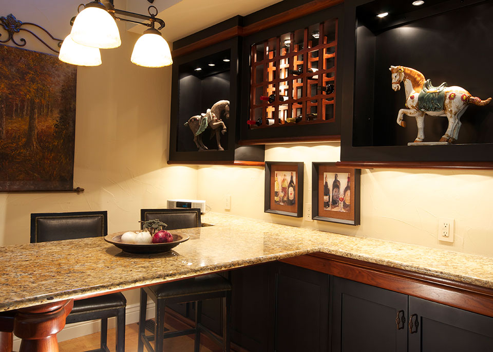 Rich woods, granite & lighting create a sophisticated kitchen table
